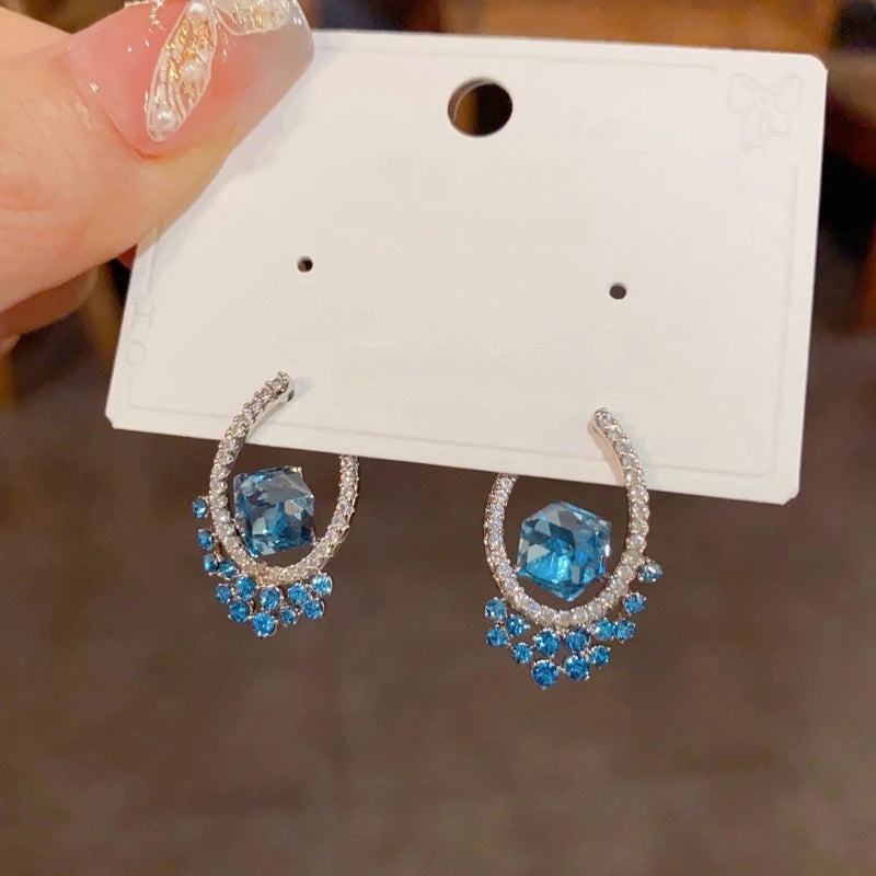 Angled view of the 14K Gold-Plated Elegant U-Shaped Blue Diamond Earrings