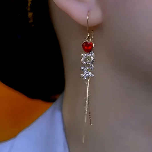 Model showcasing the dangle and style of the 14K Gold-Plated Elegant Valentine's Day Gift Red Heart Diamond Number Threader Earrings