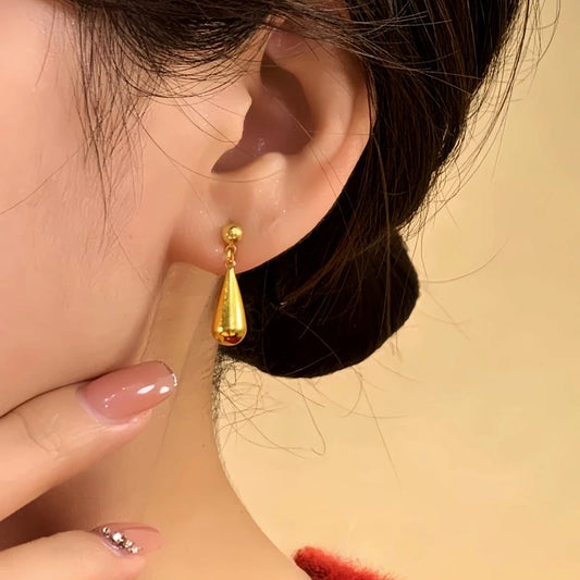 Model showcasing the dangle and style of the 14K Gold-Plated Elegant Water Drop Earrings
