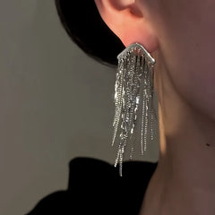 Model showcasing the dangle and style of the 14K Gold-Plated Elegant Waterfall Chain Tassel Earrings