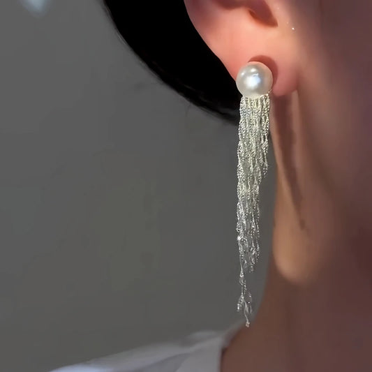 Model showcasing the dangle and style of the 14K Gold-Plated Elegant Waterfall Pearl Tassel Earrings