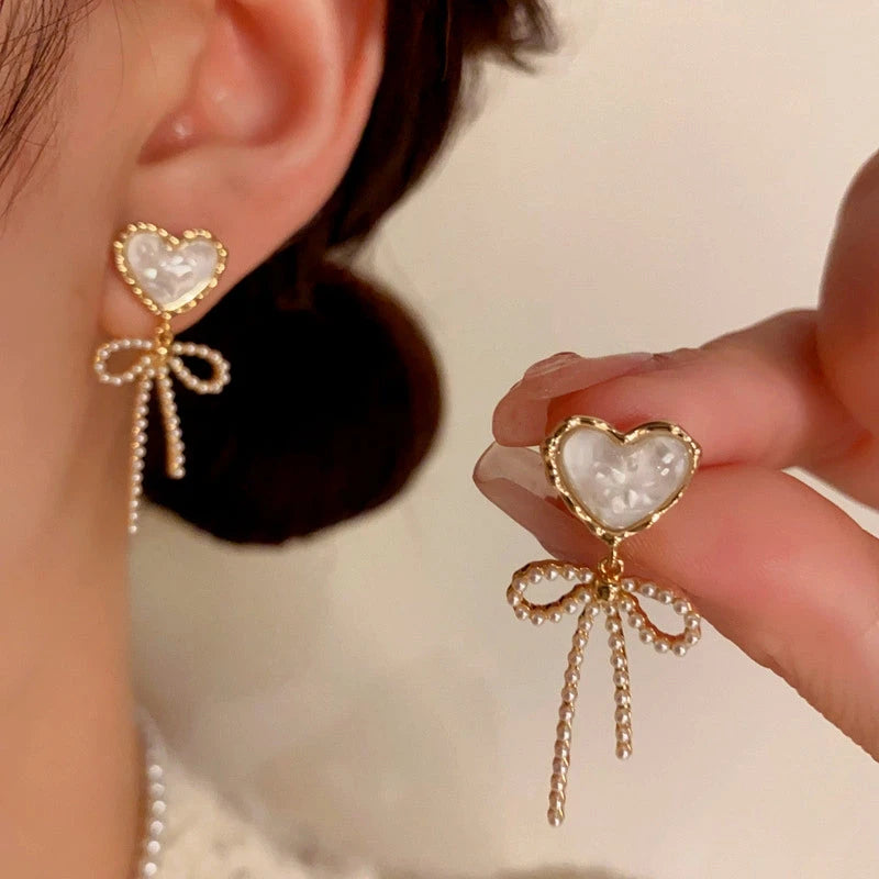 Close-up detail of the sparkling zircons and plating on the Heart Bow Earrings