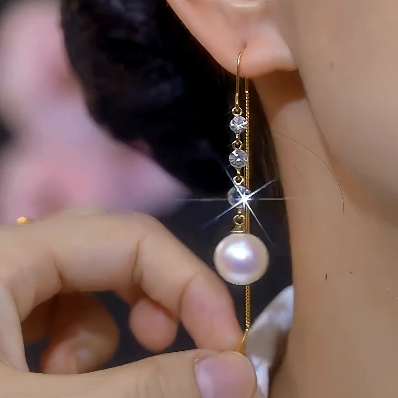 Angled view of the 14K Gold-Plated Elegant White Pearl Zircon Tassel Threader Earrings