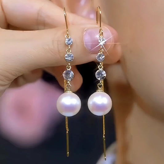 Model showcasing the dangle and style of the 14K Gold-Plated Elegant White Pearl Zircon Tassel Threader Earrings