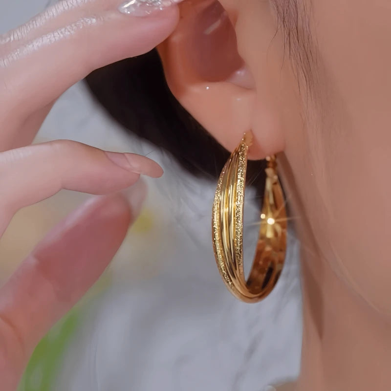 Close-up detail of the sparkling zircons and plating on the Winding Hoop Earrings