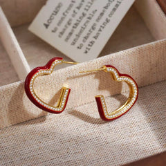 Close-up detail of the sparkling zircons and plating on the Red Heart Earrings