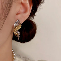 Model showcasing the dangle and style of the 14K Gold-Plated Elegant Wing Earrings