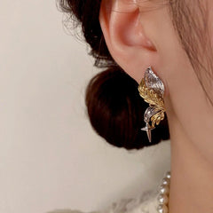 Close-up detail of the sparkling zircons and plating on the Angel Wing Earrings