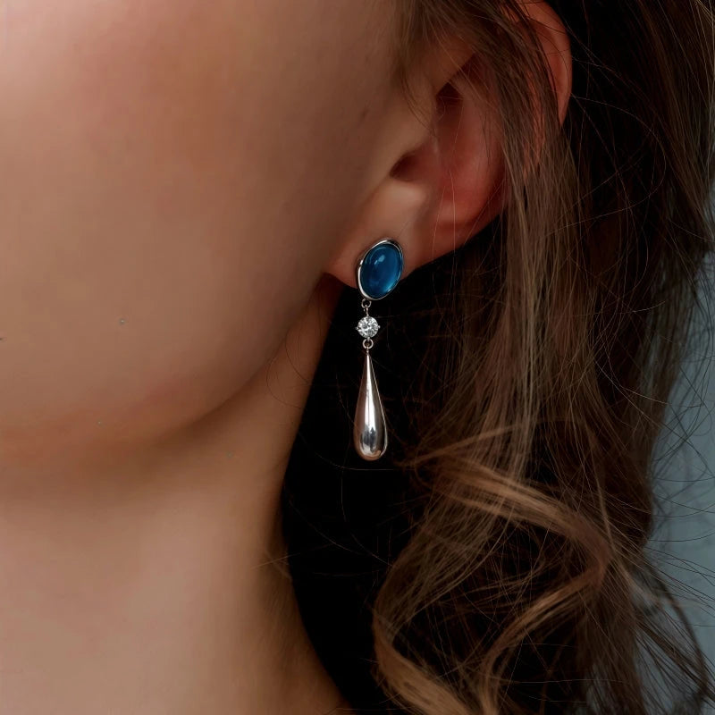 Model showcasing the dangle and style of the 14K Gold-Plated Elegant Zircon Aquamarine Water Drop Earrings