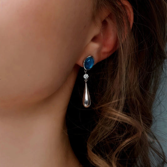 Model showcasing the dangle and style of the 14K Gold-Plated Elegant Zircon Aquamarine Water Drop Earrings