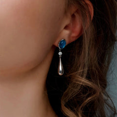 Model showcasing the dangle and style of the 14K Gold-Plated Elegant Zircon Aquamarine Water Drop Earrings
