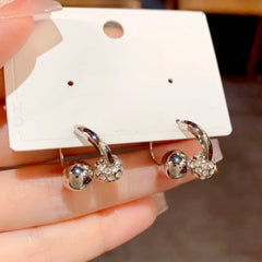 Close-up detail of the sparkling zircons and plating on the Cross Dangle Earrings