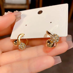 Angled view of the 14K Gold-Plated Elegant Zircon Ball Cross Earrings