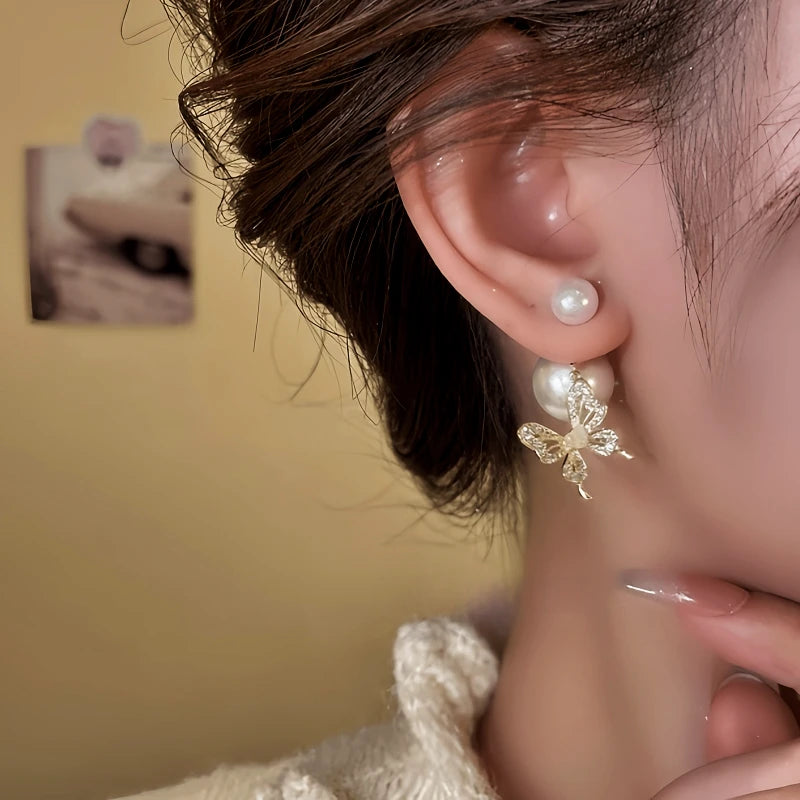 Model showcasing the dangle and style of the 14K Gold-Plated Elegant Zircon Bead Butterfly Earrings