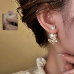 Model showcasing the dangle and style of the 14K Gold-Plated Elegant Zircon Bead Butterfly Earrings
