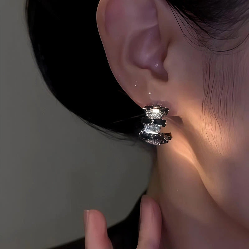 Model showcasing the dangle and style of the 14K Gold-Plated Elegant Zircon Black And Diamond C-Shaped Earrings