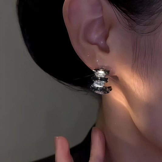 Model showcasing the dangle and style of the 14K Gold-Plated Elegant Zircon Black And Diamond C-Shaped Earrings