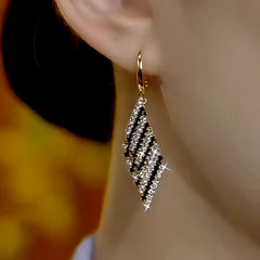 Close-up detail of the sparkling zircons and plating on the Black and White Earrings