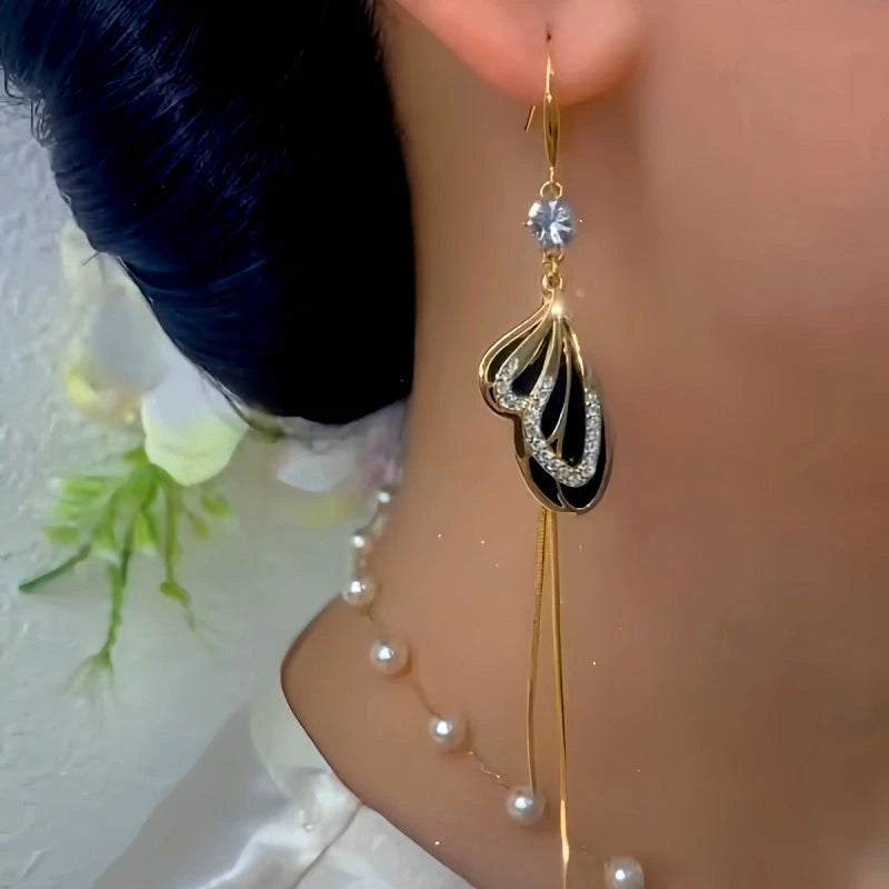 Model showcasing the dangle and style of the 14K Gold-Plated Elegant Zircon Black Butterfly Tassel Ear Hook Earrings
