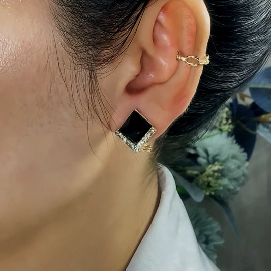 Model showcasing the dangle and style of the 14K Gold-Plated Elegant Zircon Black Crystal Earrings