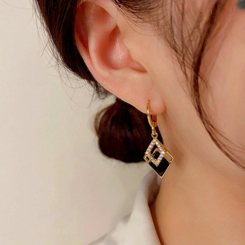 Close-up detail of the sparkling zircons and plating on the Double Drop Earrings