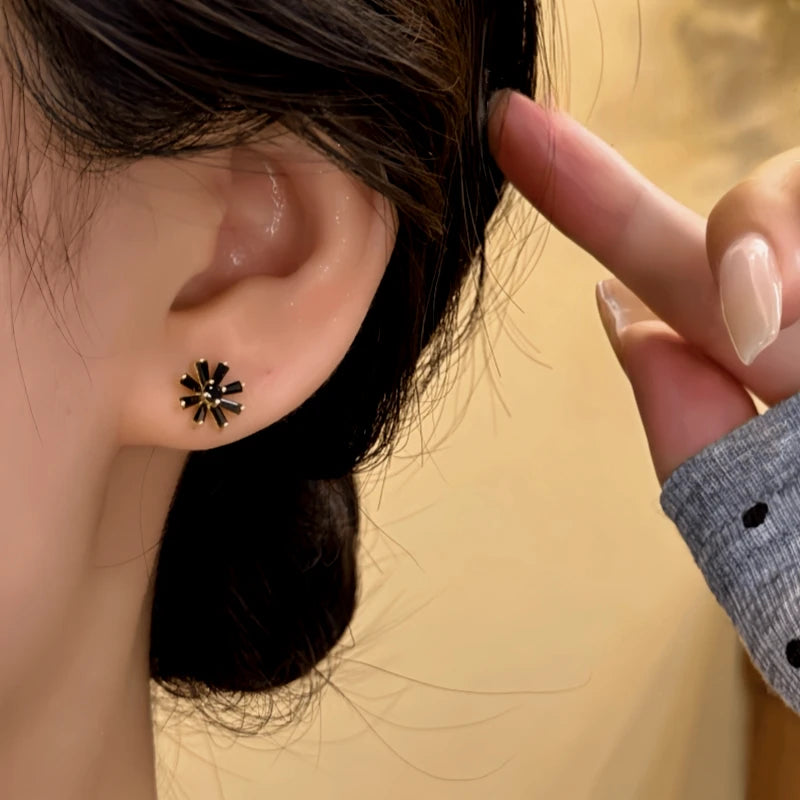 Close-up detail of the sparkling zircons and plating on the Black Sunflower Studs