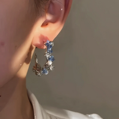 Model showcasing the dangle and style of the 14K Gold-Plated Elegant Zircon Blue Crystal Hoop Earrings