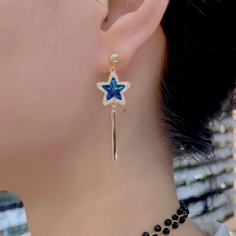 Close-up detail of the sparkling zircons and plating on the Star Tassel Earrings