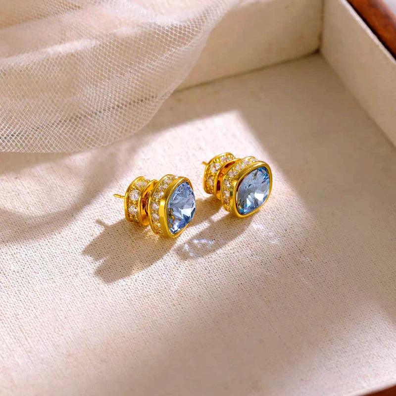 Model showcasing the dangle and style of the 14K Gold-Plated Elegant Zircon Blue Diamond Stud Earrings
