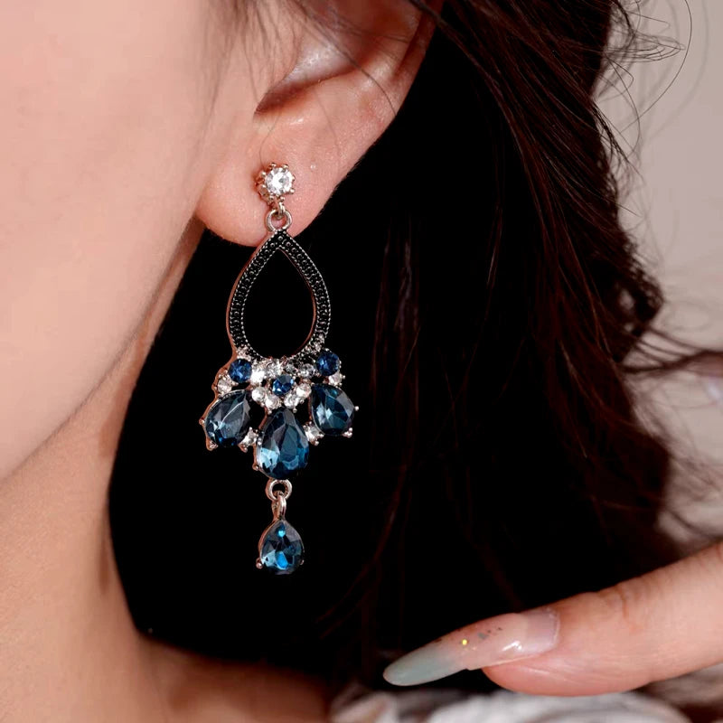 Model showcasing the dangle and style of the 14K Gold-Plated Elegant Zircon Blue Diamond Water Drop Tassel Earrings