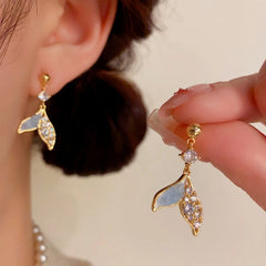 Close-up detail of the sparkling zircons and plating on the Fishtail Tassel Earrings