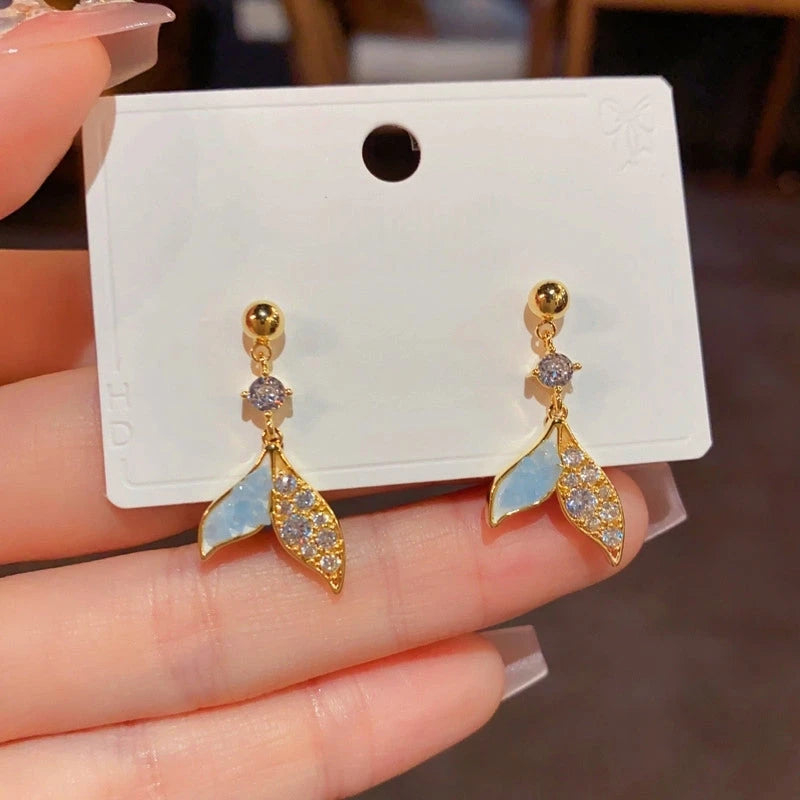 Angled view of the 14K Gold-Plated Elegant Zircon Blue Fishtail Tassel Earrings