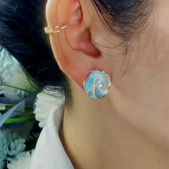 Model showcasing the dangle and style of the 14K Gold-Plated Elegant Zircon Blue Flower Earrings