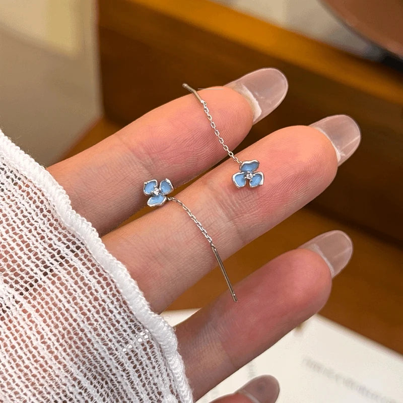 Angled view of the 14K Gold-Plated Elegant Zircon Blue Iris Flower Threader Earrings