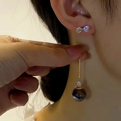 Close-up detail of the sparkling zircons and plating on the Black Pearl Tassel Earrings