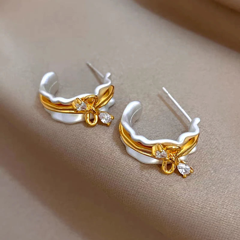 Angled view of the 14K Gold-Plated Elegant Zircon Bow C-Shaped Earrings