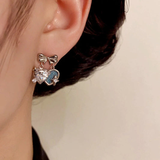 Model showcasing the dangle and style of the 14K Gold-Plated Elegant Zircon Bow Double Heart Earrings