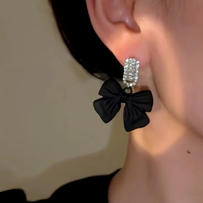 Close-up detail of the sparkling zircons and plating on the Black Bow Earrings