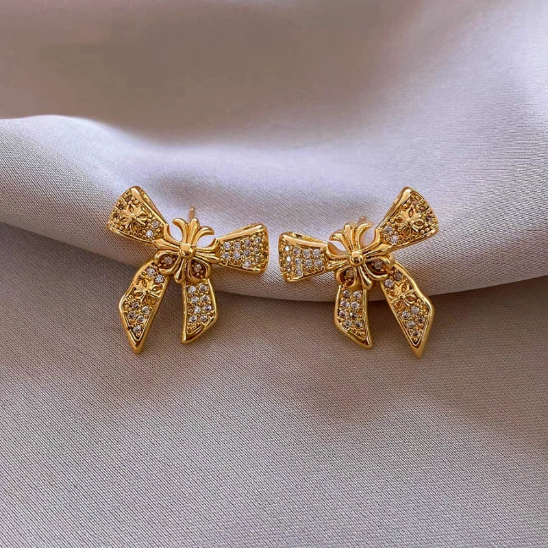 Angled view of the 14K Gold-Plated Elegant Zircon Bow Earrings