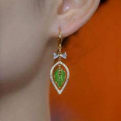 Model showcasing the dangle and style of the 14K Gold-Plated Elegant Zircon Bow Green Leaf Earrings