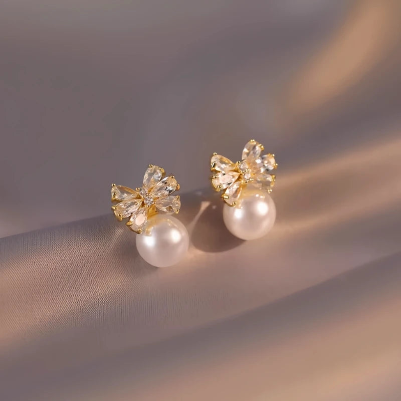 Close-up detail of the sparkling zircons and plating on the Bow Pearl Earrings