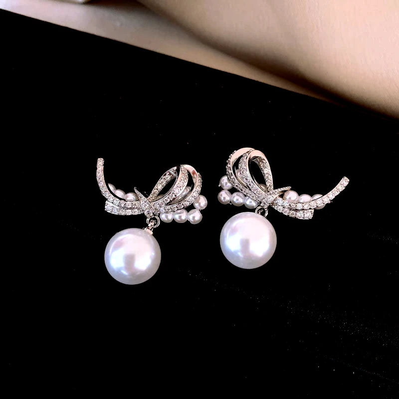Angled view of the 14K Gold-Plated Elegant Zircon Bow Pearl Earrings