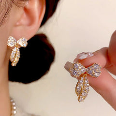 Close-up detail of the sparkling zircons and plating on the Bow Tassel Earrings