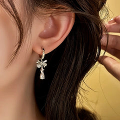 Model showcasing the dangle and style of the 14K Gold-Plated Elegant Zircon Bow Water Drop Earrings