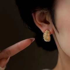 Close-up detail of the sparkling zircons and plating on the Gold Twist Earrings