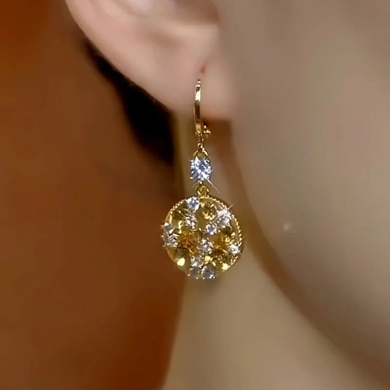 Model showcasing the dangle and style of the 14K Gold-Plated Elegant Zircon Brown Diamond Water Drop Earrings