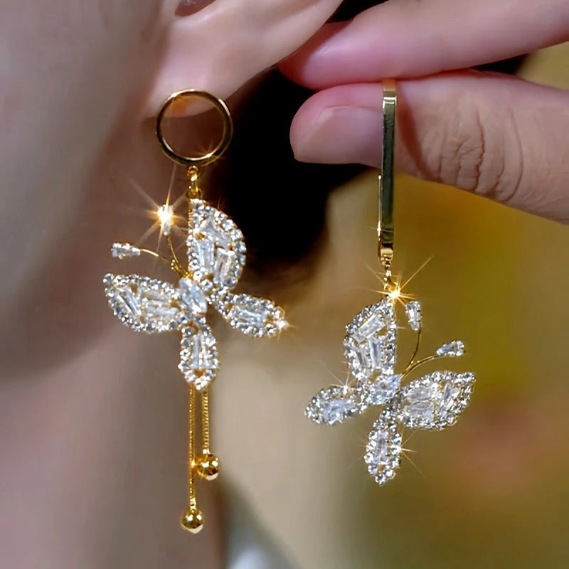 Model showcasing the dangle and style of the 14K Gold-Plated Elegant Zircon Butterfly Asymmetrical Earrings