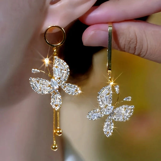 Model showcasing the dangle and style of the 14K Gold-Plated Elegant Zircon Butterfly Asymmetrical Earrings