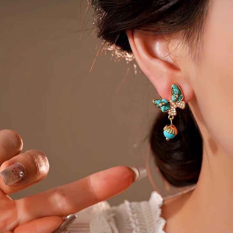 Model showcasing the dangle and style of the 14K Gold-Plated Elegant Zircon Butterfly Bohemian Earrings