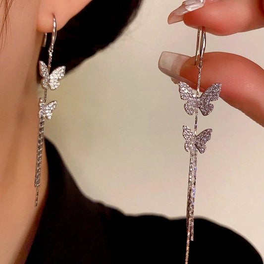 Model showcasing the dangle and style of the 14K Gold-Plated Elegant Zircon Butterfly Ear Hook Tassel Earrings